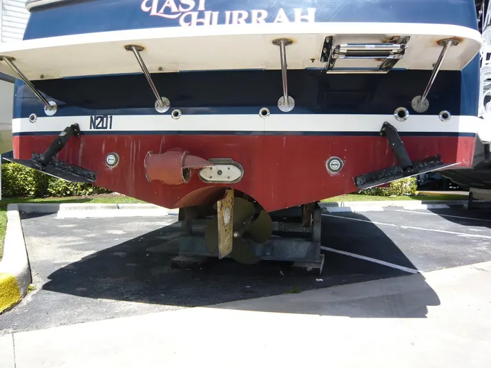 Last Hurrah Yacht Photos Pics 2008 Back Cove 29 boat stern view, showcasing propeller and trim tabs in a parking area.