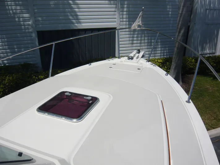 Last Hurrah Yacht Photos Pics 2008 Back Cove 29 boat deck with hatch and railing, docked near a building.