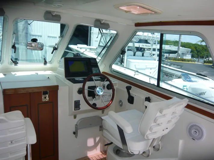 Last Hurrah Yacht Photos Pics 2008 Back Cove 29 boat interior with steering wheel and navigation equipment.