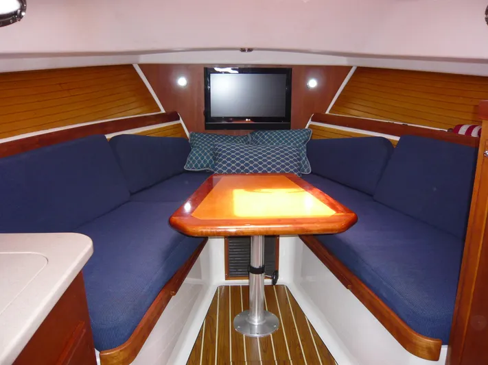 Last Hurrah Yacht Photos Pics 2008 Back Cove 29 interior with blue seating, wooden table, and modern design.
