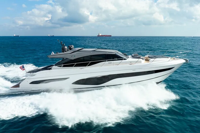 Fly By Yacht Photos Pics 2019 Princess V65 yacht cruising on open sea under cloudy sky.