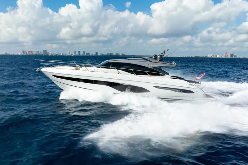 Fly By Yacht Photos Pics 2019 Princess V65 yacht cruising on open water under a partly cloudy sky.