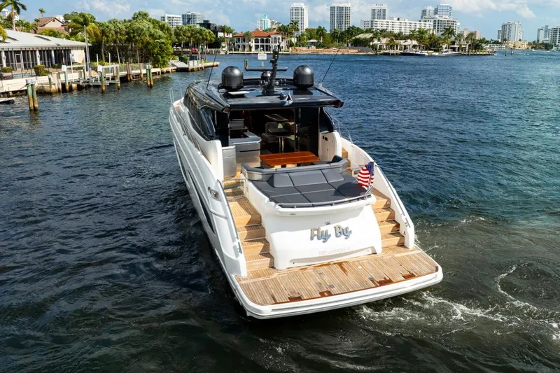 Fly By Yacht Photos Pics 2019 Princess V65 yacht cruising in a scenic waterfront setting.