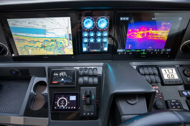 Fly By Yacht Photos Pics Control panel of 2019 Princess V65 yacht with navigation and monitoring screens.