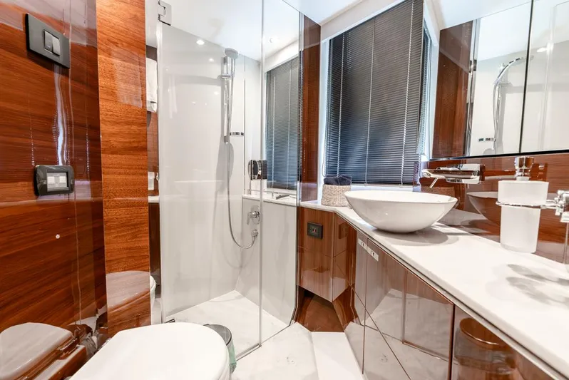 Fly By Yacht Photos Pics Luxurious bathroom in 2019 Princess V65 yacht with modern fixtures and wooden accents.