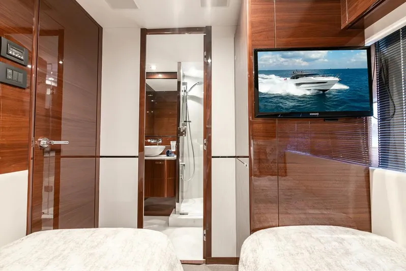 Fly By Yacht Photos Pics Luxurious interior of 2019 Princess V65 yacht with twin beds and wall-mounted TV.