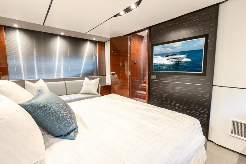 Fly By Yacht Photos Pics Luxurious bedroom interior of 2019 Princess V65 yacht with modern decor and ocean view.