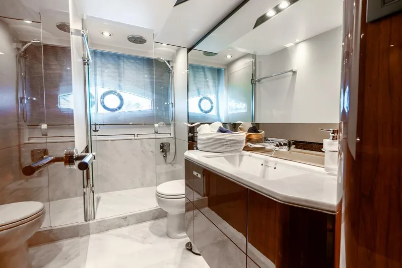 Fly By Yacht Photos Pics Luxurious bathroom in a 2019 Princess V65 yacht, featuring modern fixtures and elegant design.