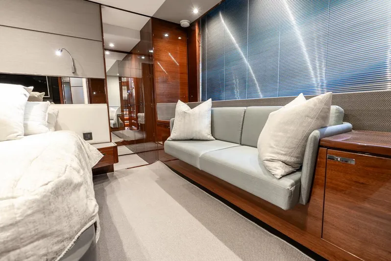 Fly By Yacht Photos Pics Luxurious interior of 2019 Princess V65 yacht with modern sofa and elegant decor.