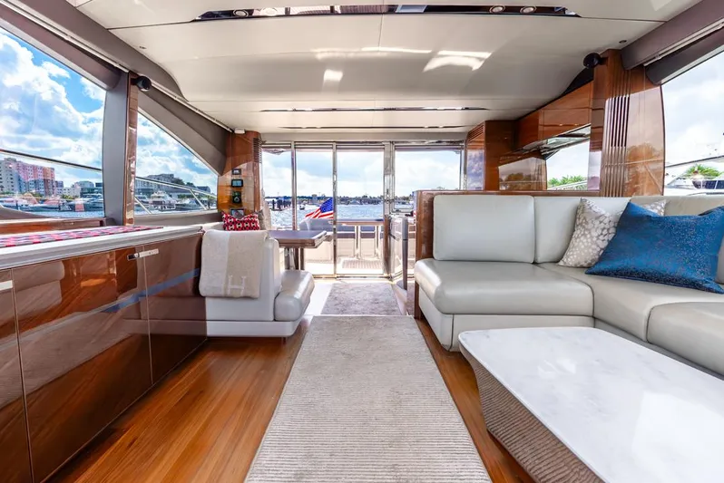 Fly By Yacht Photos Pics Luxurious interior of 2019 Princess V65 yacht with elegant seating and panoramic windows.