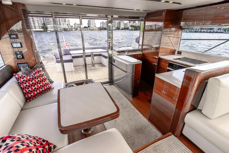 Fly By Yacht Photos Pics Luxurious interior of 2019 Princess V65 yacht with elegant seating and waterfront view.