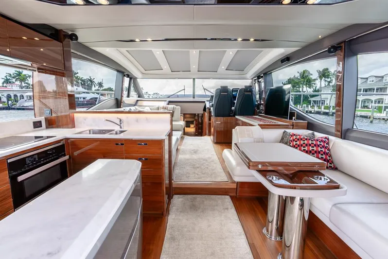 Fly By Yacht Photos Pics Luxurious interior of 2019 Princess V65 yacht with modern kitchen and seating area.