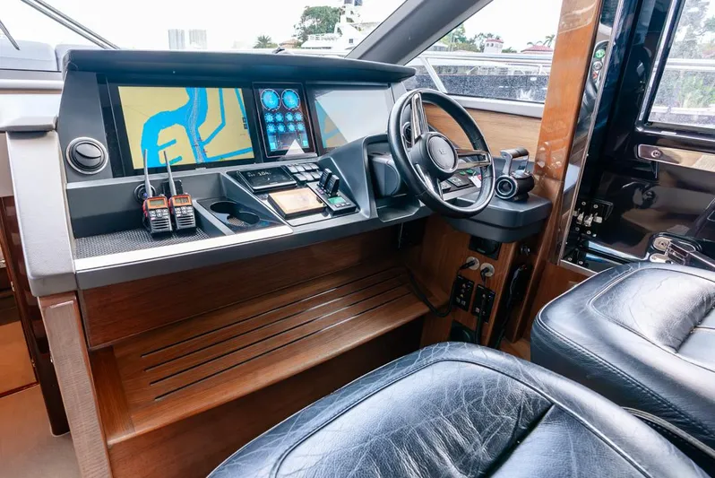 Fly By Yacht Photos Pics 2019 Princess V65 yacht helm with navigation screens and leather seating.