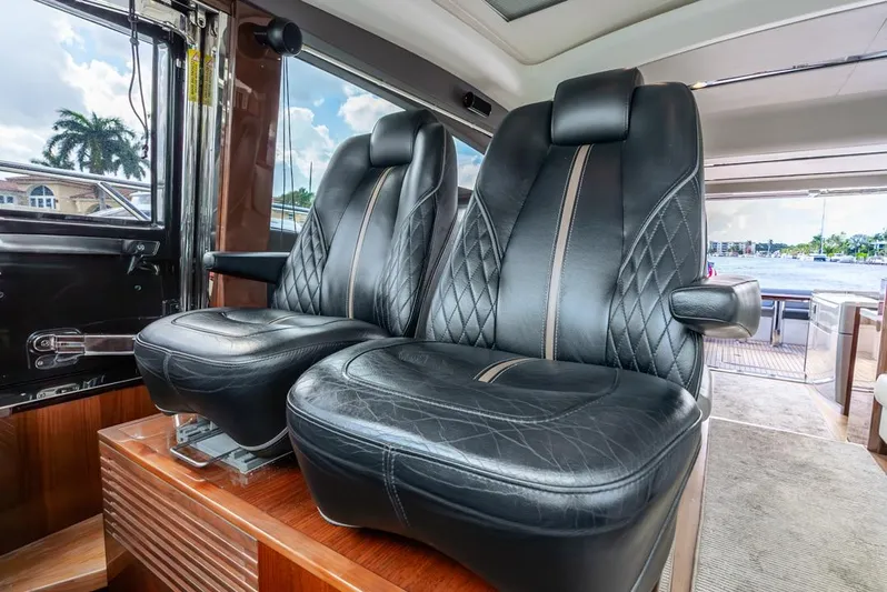 Fly By Yacht Photos Pics Luxurious leather seats inside a 2019 Princess V65 yacht, showcasing elegant design.