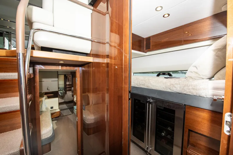 Fly By Yacht Photos Pics Interior of 2019 Princess V65 yacht with luxurious wood finishes and modern amenities.