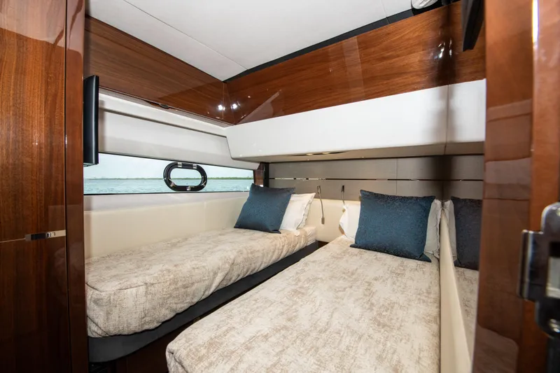 Fly By Yacht Photos Pics Luxurious twin cabin interior of 2019 Princess V65 yacht with elegant wood finishes.