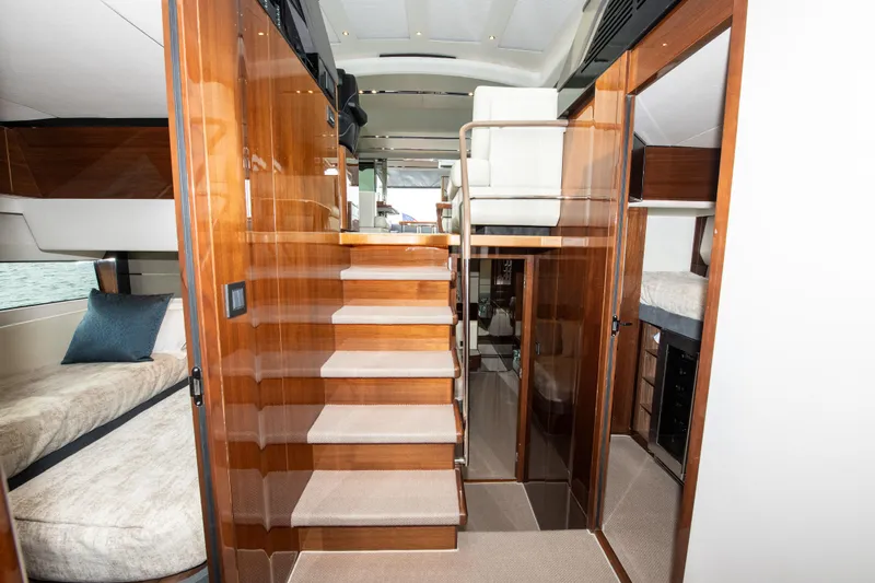 Fly By Yacht Photos Pics Luxurious interior of 2019 Princess V65 yacht with wooden finishes and modern design.