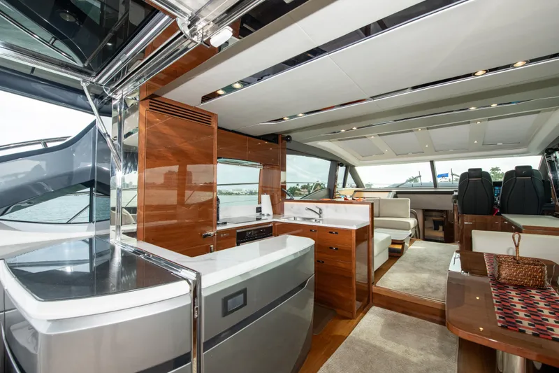 Fly By Yacht Photos Pics Luxurious interior of 2019 Princess V65 yacht with modern kitchen and seating area.