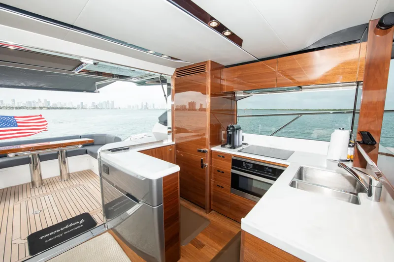 Fly By Yacht Photos Pics Luxurious 2019 Princess V65 yacht interior with modern kitchen and ocean view.