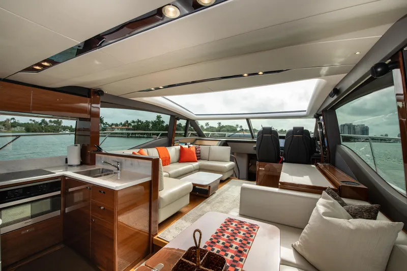 Fly By Yacht Photos Pics Luxurious interior of 2019 Princess V65 yacht with modern furnishings and panoramic windows.