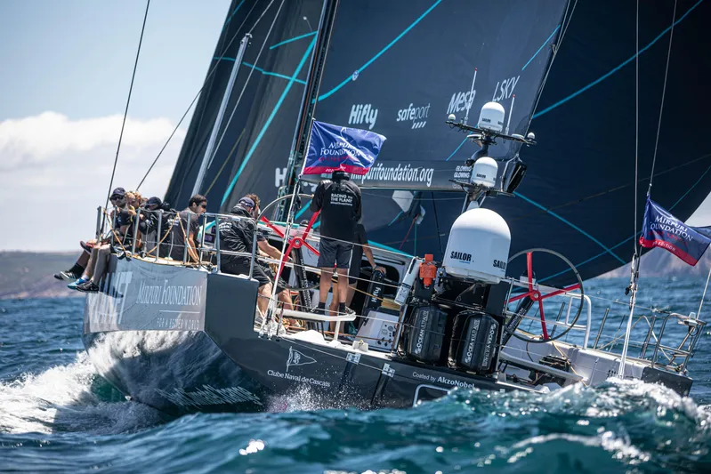  Yacht Photos Pics Sailing crew on 2014 Farr Volvo Ocean 65 yacht navigating ocean waves.