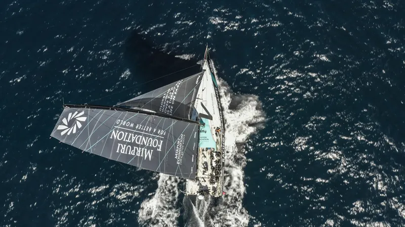  Yacht Photos Pics Aerial view of 2014 Farr Volvo Ocean 65 sailing in open sea.