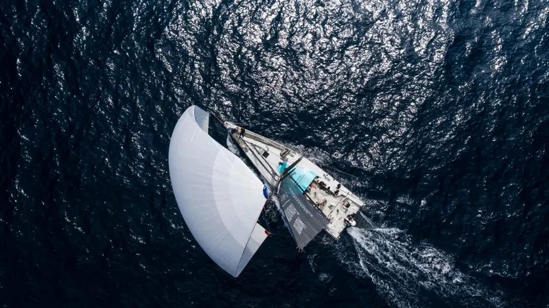  Yacht Photos Pics Aerial view of 2014 Farr Volvo Ocean 65 sailing on open sea.
