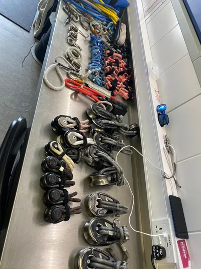  Yacht Photos Pics Assorted sailing hardware on a table, including blocks and ropes, for a 2014 Farr Volvo Ocean 65.