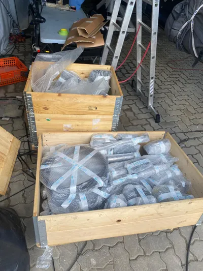  Yacht Photos Pics Wooden crates with packaged parts for a 2014 Farr Volvo Ocean 65 sailboat.