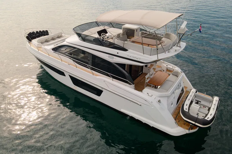  Yacht Photos Pics 2023 Azimut 53 yacht on calm water, featuring a sleek design and spacious deck.