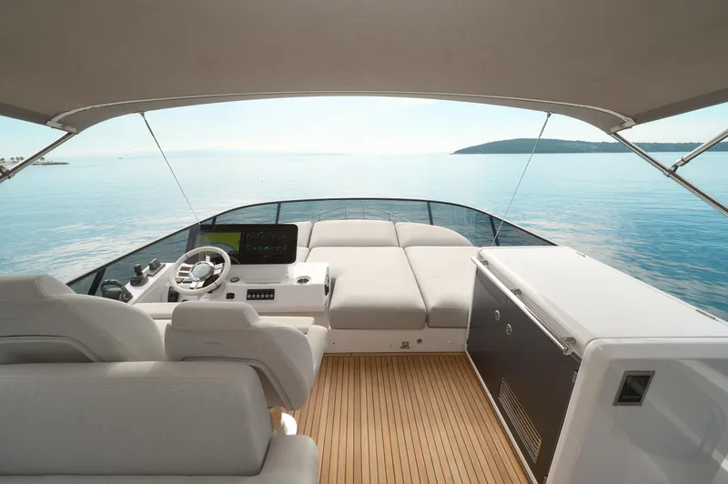  Yacht Photos Pics 2023 Azimut 53 yacht interior with helm, seating, and ocean view.