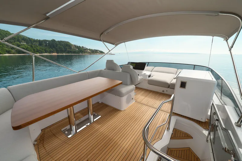  Yacht Photos Pics Luxurious 2023 Azimut 53 yacht deck with elegant seating and ocean view.