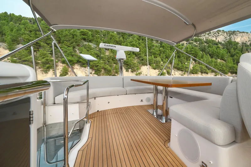  Yacht Photos Pics Luxurious 2023 Azimut 53 yacht deck with elegant seating and scenic views.