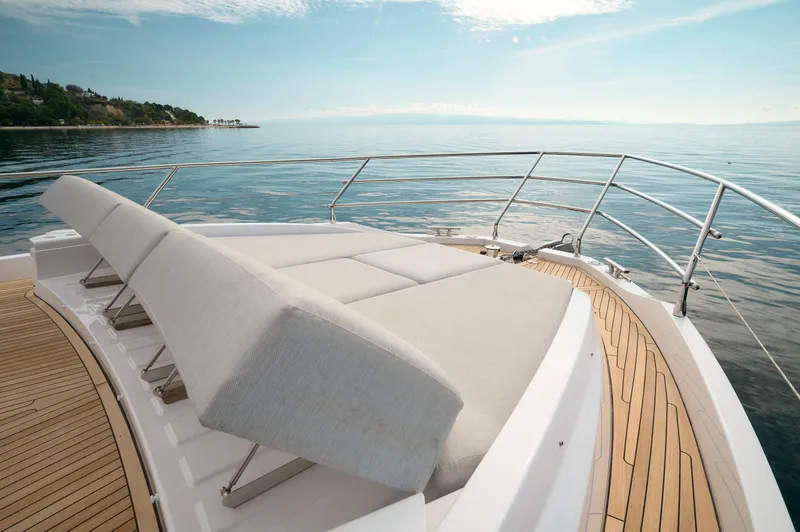  Yacht Photos Pics Luxurious 2023 Azimut 53 yacht deck with sun loungers and ocean view.