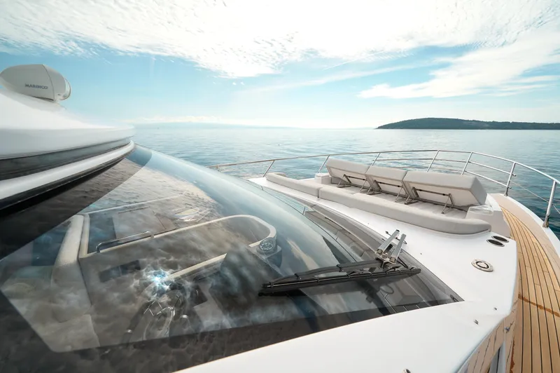  Yacht Photos Pics 2023 Azimut 53 yacht with sleek design, cruising on calm waters under a clear sky.