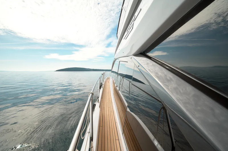  Yacht Photos Pics 2023 Azimut 53 yacht cruising on calm waters under a partly cloudy sky.