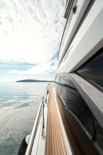  Yacht Photos Pics 2023 Azimut 53 yacht cruising on calm waters under a partly cloudy sky.