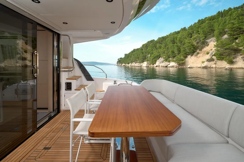  Yacht Photos Pics Luxurious 2023 Azimut 53 yacht deck with elegant seating and scenic ocean view.