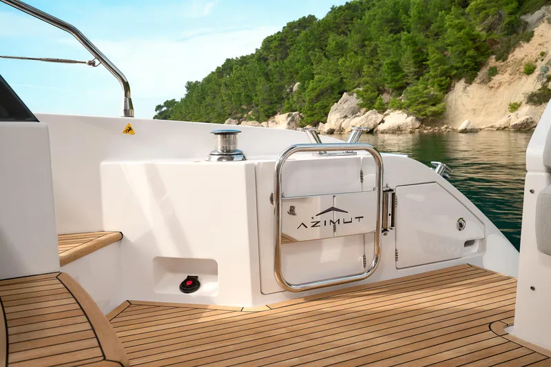  Yacht Photos Pics 2023 Azimut 53 yacht deck with scenic coastal backdrop.