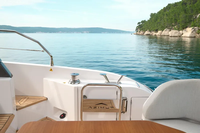  Yacht Photos Pics 2023 Azimut 53 yacht deck with scenic ocean view and lush coastline.