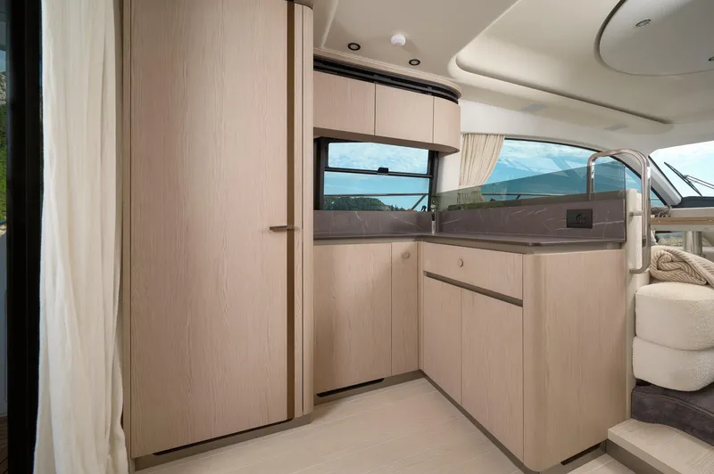  Yacht Photos Pics Luxurious interior of 2023 Azimut 53 yacht, featuring modern cabinetry and sleek design.