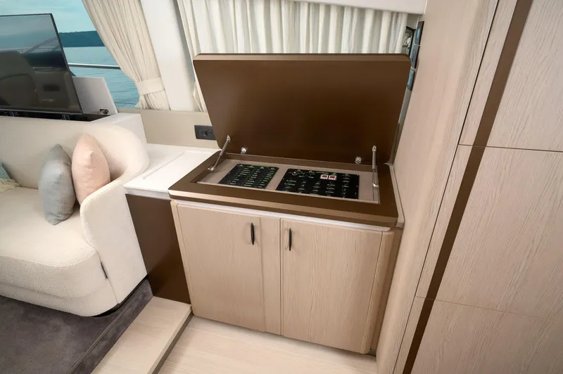  Yacht Photos Pics Luxurious interior of 2023 Azimut 53 yacht with modern kitchenette and seating area.