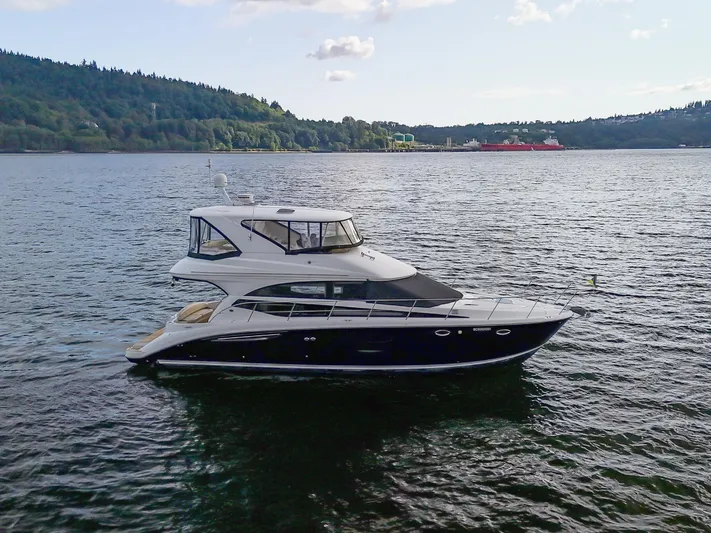 Serenity Yacht Photos Pics 2012 Meridian 441 Sedan yacht cruising on a scenic lake with forested hills.