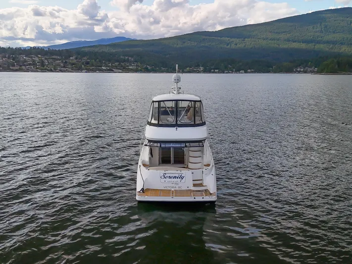 Serenity Yacht Photos Pics Meridian 441 Sedan 2012 yacht on calm water with scenic mountain backdrop.
