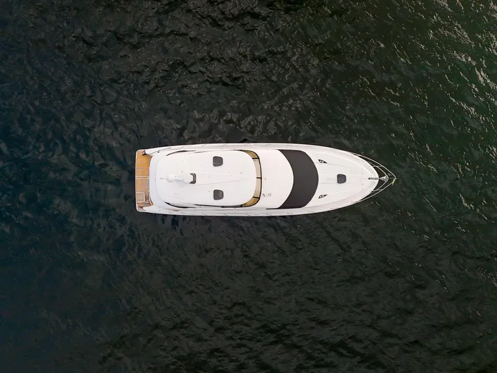 Serenity Yacht Photos Pics Aerial view of 2012 Meridian 441 Sedan yacht on dark water.
