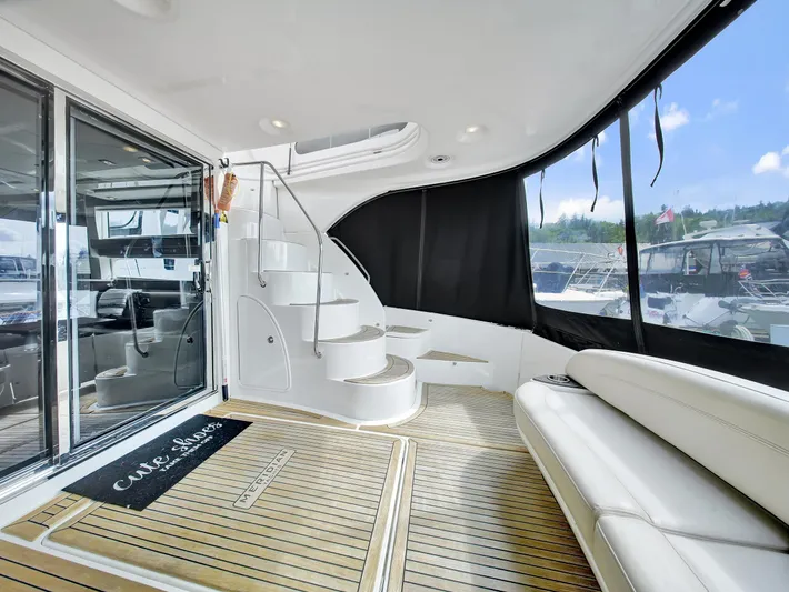 Serenity Yacht Photos Pics Luxurious 2012 Meridian 441 Sedan yacht interior with elegant seating and spiral staircase.