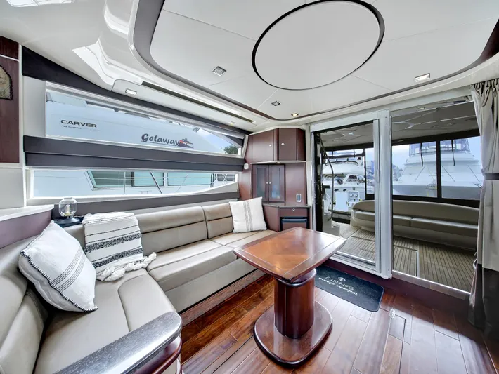 Serenity Yacht Photos Pics Luxurious interior of a 2012 Meridian 441 Sedan yacht with elegant seating and wooden table.