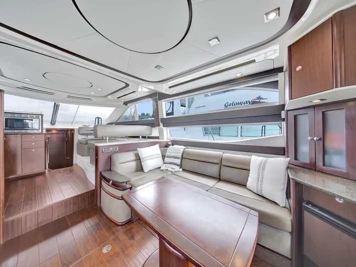 Serenity Yacht Photos Pics Luxurious interior of 2012 Meridian 441 Sedan yacht with elegant seating and wood finishes.