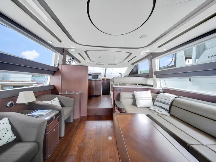 Serenity Yacht Photos Pics Luxurious interior of 2012 Meridian 441 Sedan yacht with modern furnishings and panoramic windows.