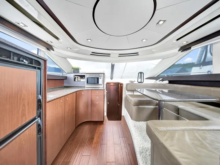 Serenity Yacht Photos Pics Luxurious interior of 2012 Meridian 441 Sedan yacht with modern kitchen and dining area.